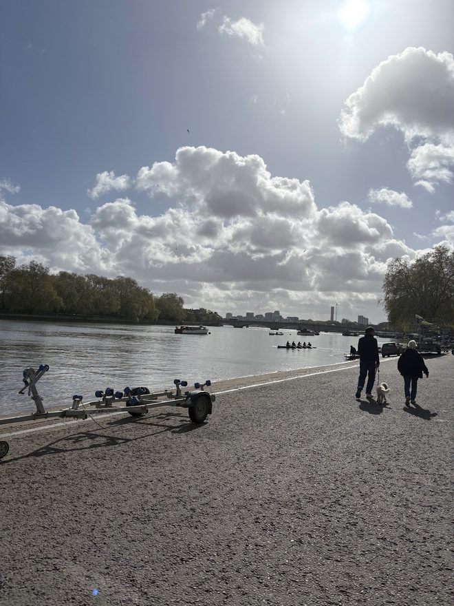 The riverside towpath under a bright cloudy sky