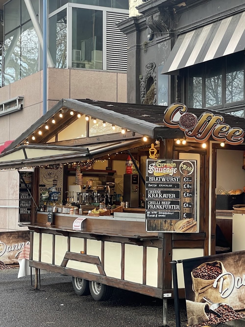 The wooden coffee and hot dog trailer on Putney Embankment, strung with fairy lights